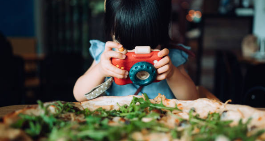 a child taking picture of the food