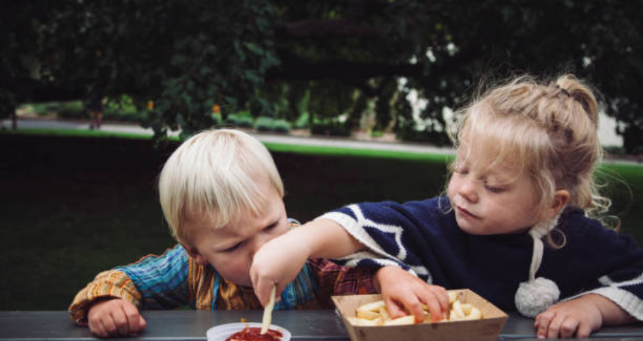 two kids eating together