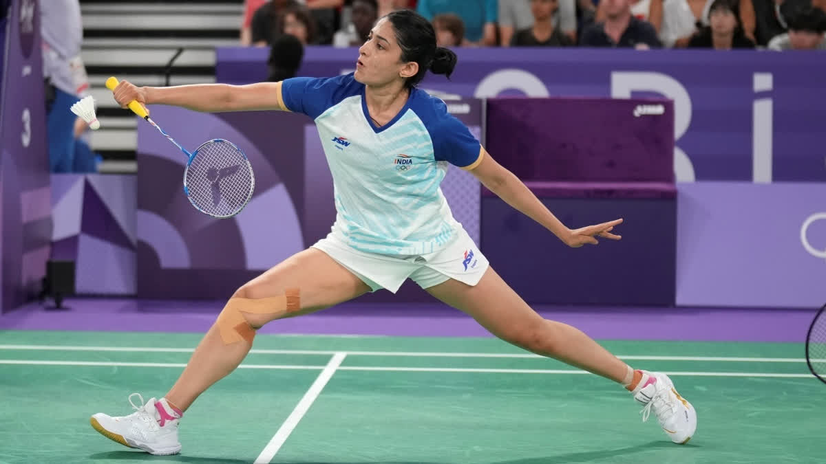 Ashwini Ponnappa is captured mid-swing, delivering a powerful shot during a match.