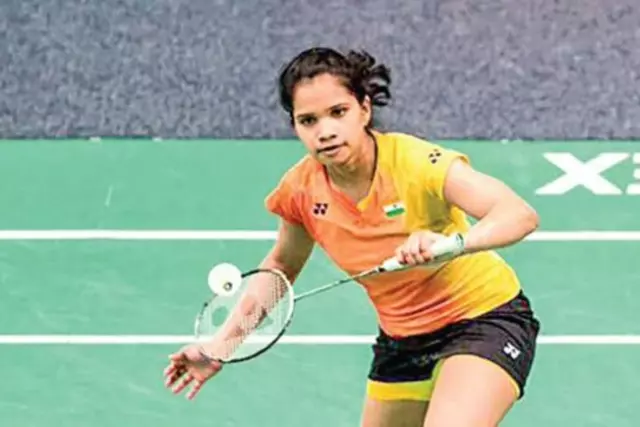 Sikki Reddy smiles brightly in a close-up shot, holding her badminton racket confidently. Known for her excellent doubles coordination, she won a silver medal at the 2018 Commonwealth Games.