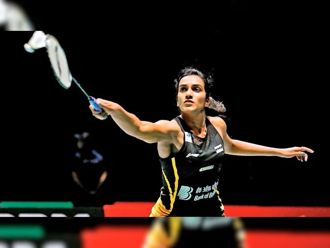 P.V. Sindhu is captured in action on the badminton court, wearing a sports jersey, showcasing her focus as she prepares to deliver a decisive shot. A legend with 2 Olympic medals to her name.