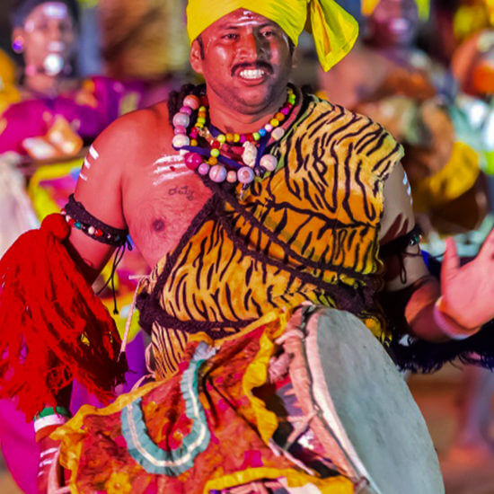 Male performer in Dollu Kunitha, wearing traditional attire