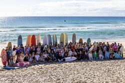 surfers with colorful surfboards gathered near the ocean, capturing the adventurous and vibrant surf culture of Australia.