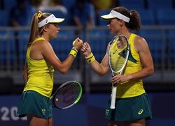 Australian women tennis squad of 2 players cheering each reflecting their team spirit and competitive edge.