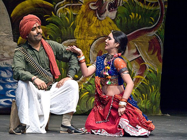 A lively Nautanki performance with actors in traditional costumes.