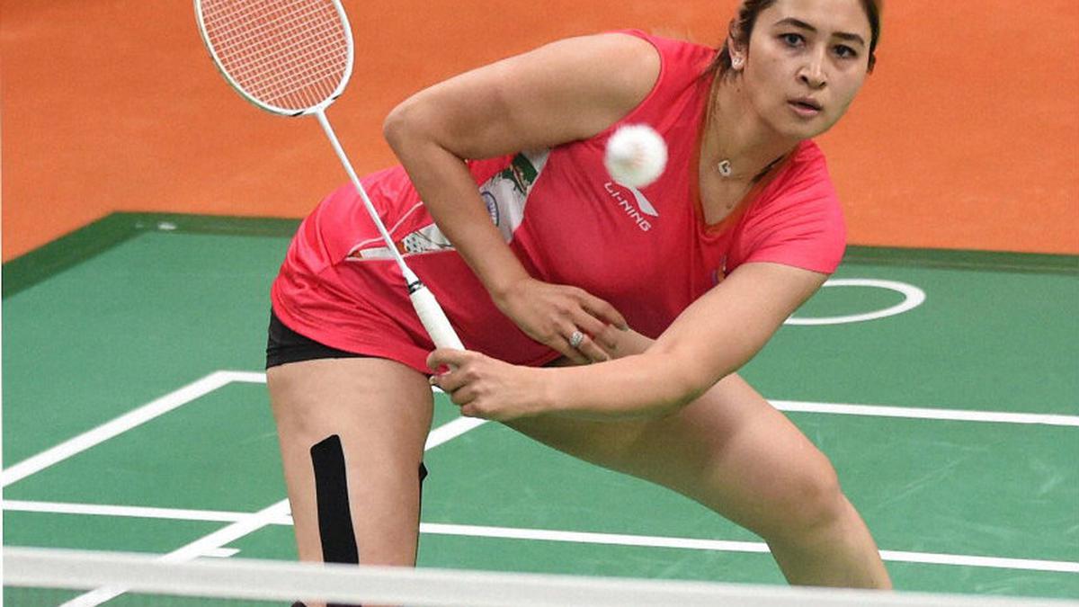 Jwala Gutta, positioned near the net, prepares to return a shot with her signature style.