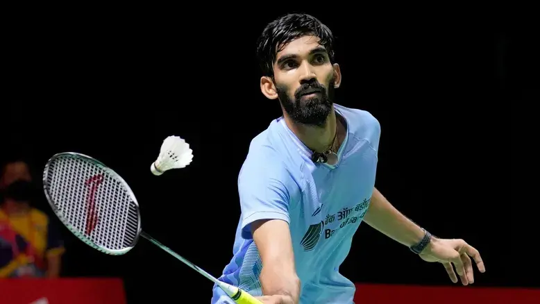 Kidambi Srikanth is poised mid-game, about to smash the shuttlecock, reflecting his agility and skill.