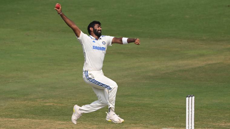 Jasprit Bumrah mid-action during a cricket match, delivering a powerful right-arm fast ball in India’s cricket jersey.