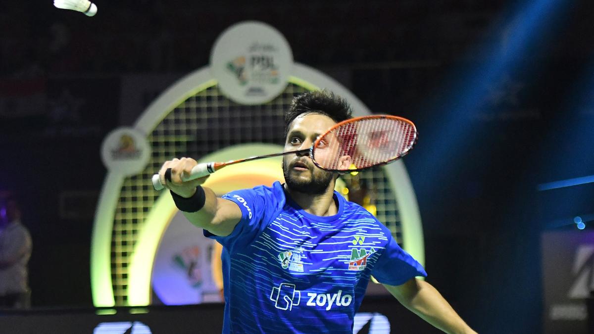 Parupalli Kashyap leaps mid-air during a game, aiming to smash the shuttlecock with precision.