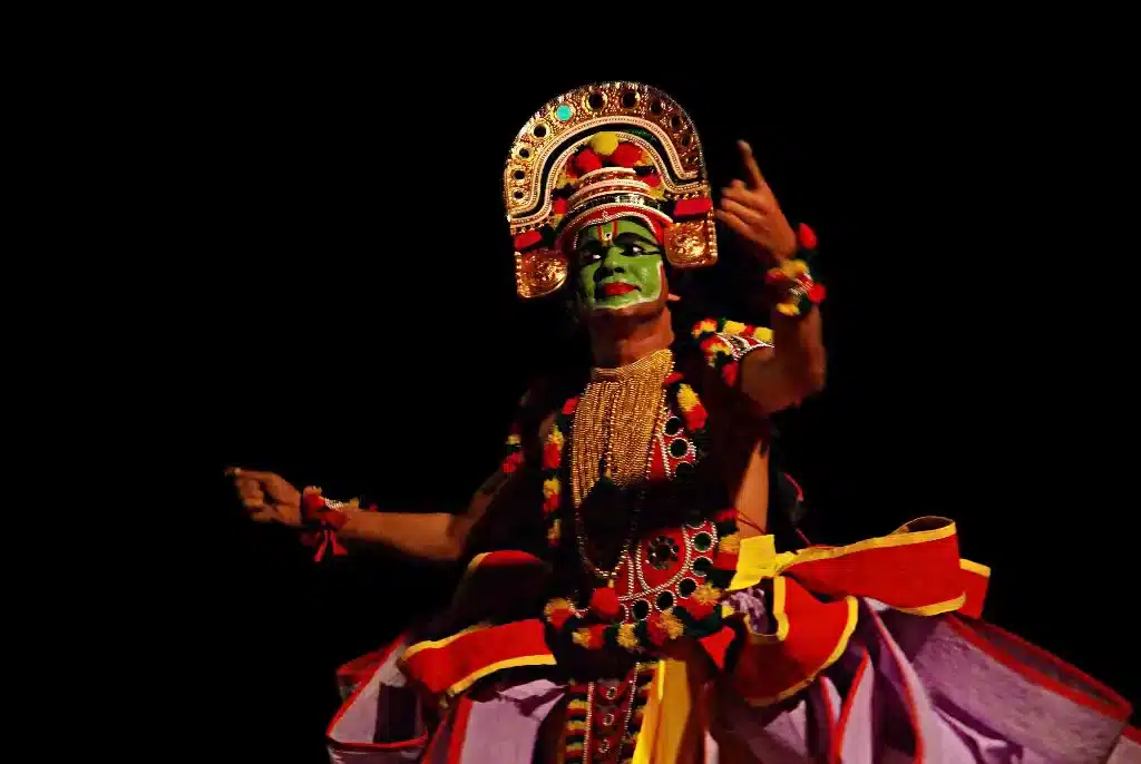 A solo performer in colorful costume with exaggerated facial expressions, performing Ottamthullal