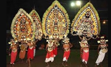 Dancers in colorful, large masks performing Padayani, a vibrant ritual dance to honor Goddess Bhadrakali