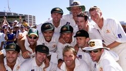 A historic photograph of 11 legendary Australian cricket players in full test format jerseys, 