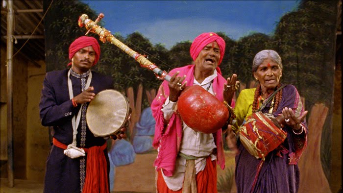 Traditional musical instruments like the mridangam, flute, and tambura arranged for a Butta Bommalu dance performance.