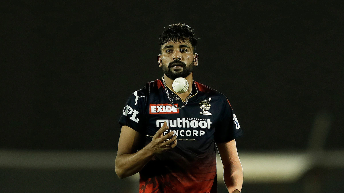 Mohammed Siraj in the Indian cricket jersey, celebrating after taking a crucial wicket during a match.