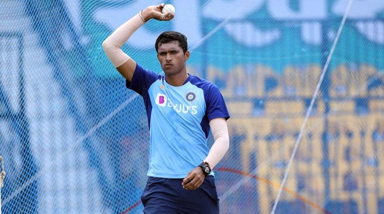 Navdeep Saini, in the Indian cricket team jersey, captured mid-run-up while bowling a fast delivery.