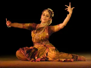 A dancer performing the Bhamakalpam dance, a blend of dance and drama with intricate facial expressions and hand gestures.